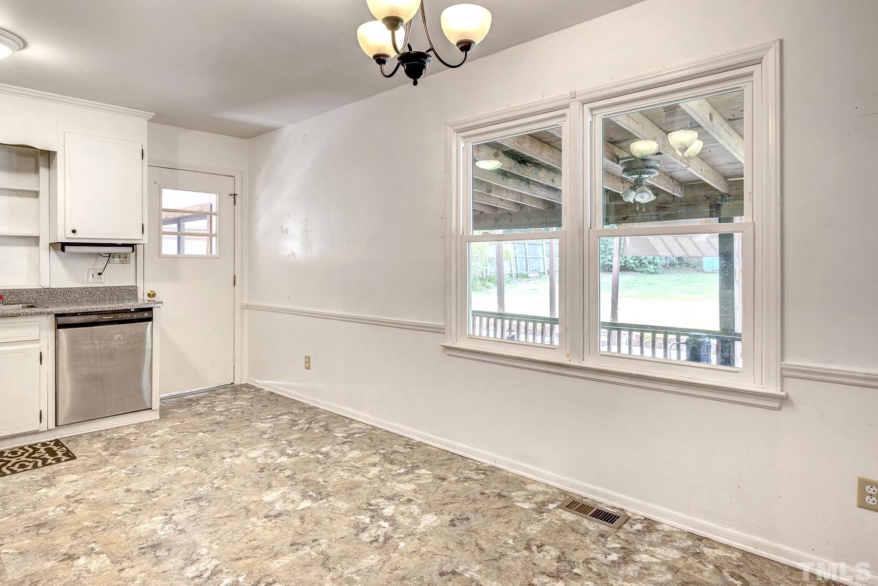 5816 Neuse Street Raleigh, NC 27610 - Photo 5 of 32 a view of a kitchen with wooden floor and a window
