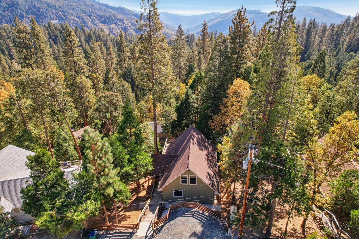 20819 Muheli Road Mi Wuk Village, CA 95346 - Photo 13 of 49 a backyard of a house with outdoor seating and trees