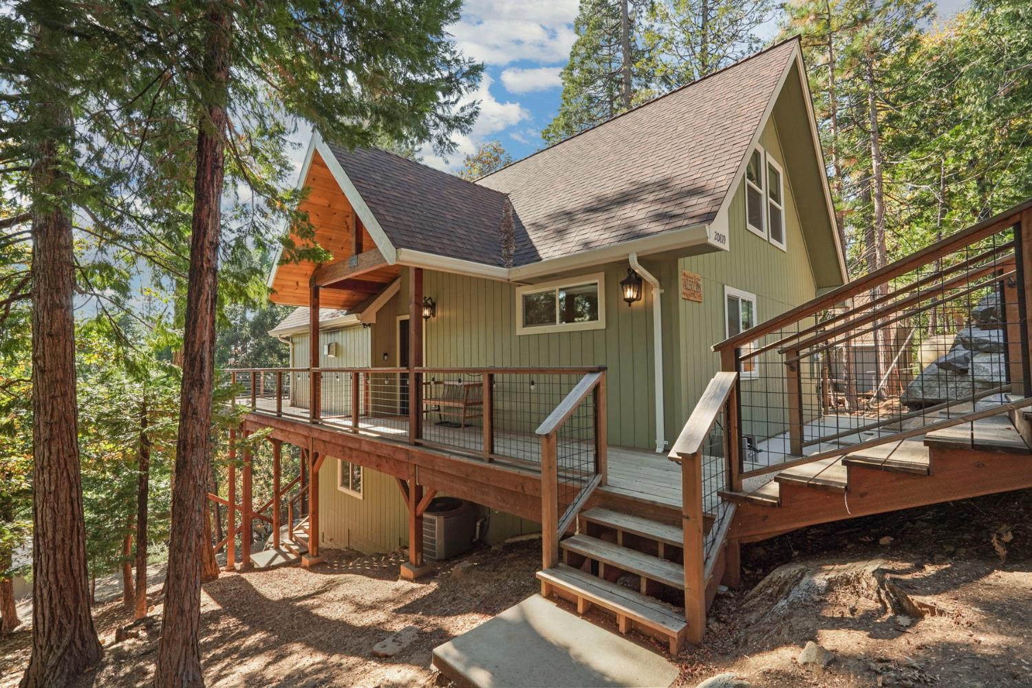20819 Muheli Road Mi Wuk Village, CA 95346 - Photo 2 of 49 a front view of a house with a yard