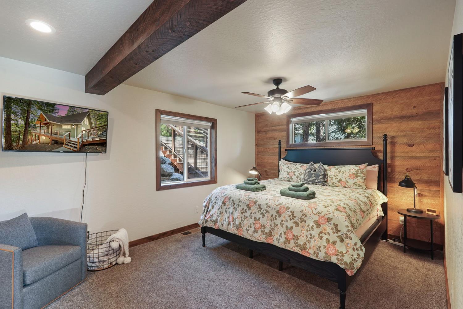 20819 Muheli Road Mi Wuk Village, CA 95346 - Photo 27 of 49 a bedroom with a bed a couch and painting on the wall