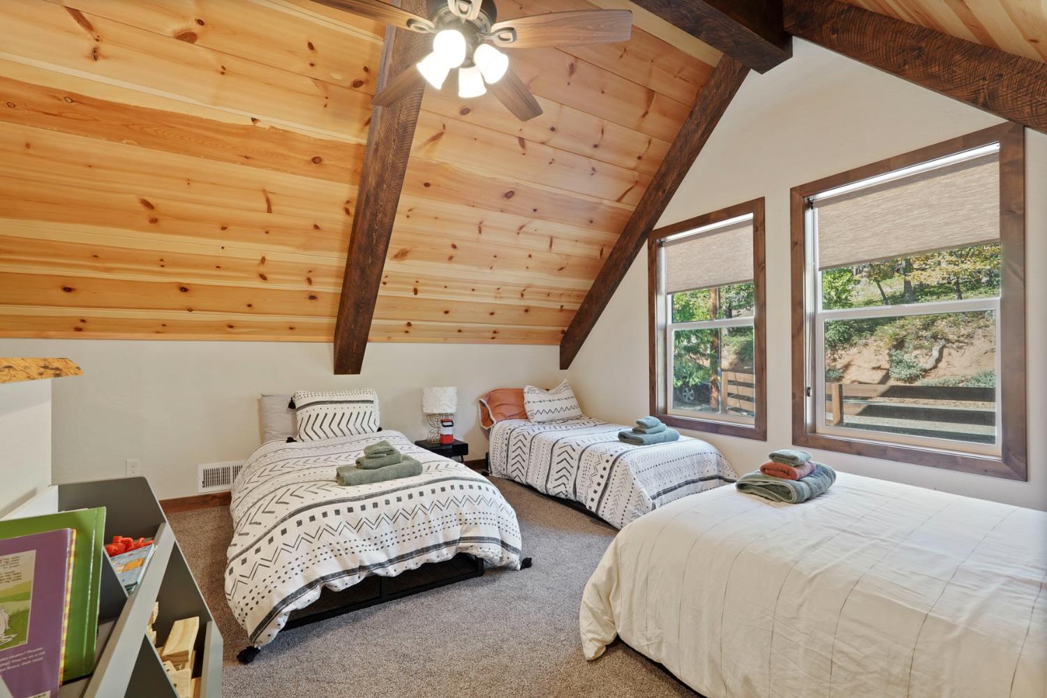 20819 Muheli Road Mi Wuk Village, CA 95346 - Photo 34 of 49 a bedroom with two beds and a large window