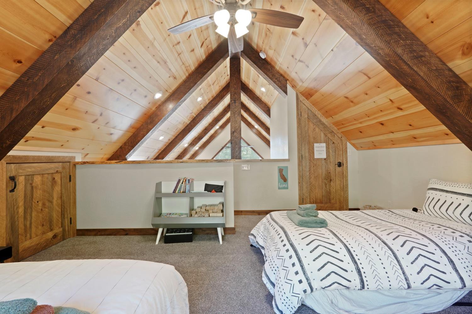 20819 Muheli Road Mi Wuk Village, CA 95346 - Photo 35 of 49 a bedroom with a bed and a chandelier