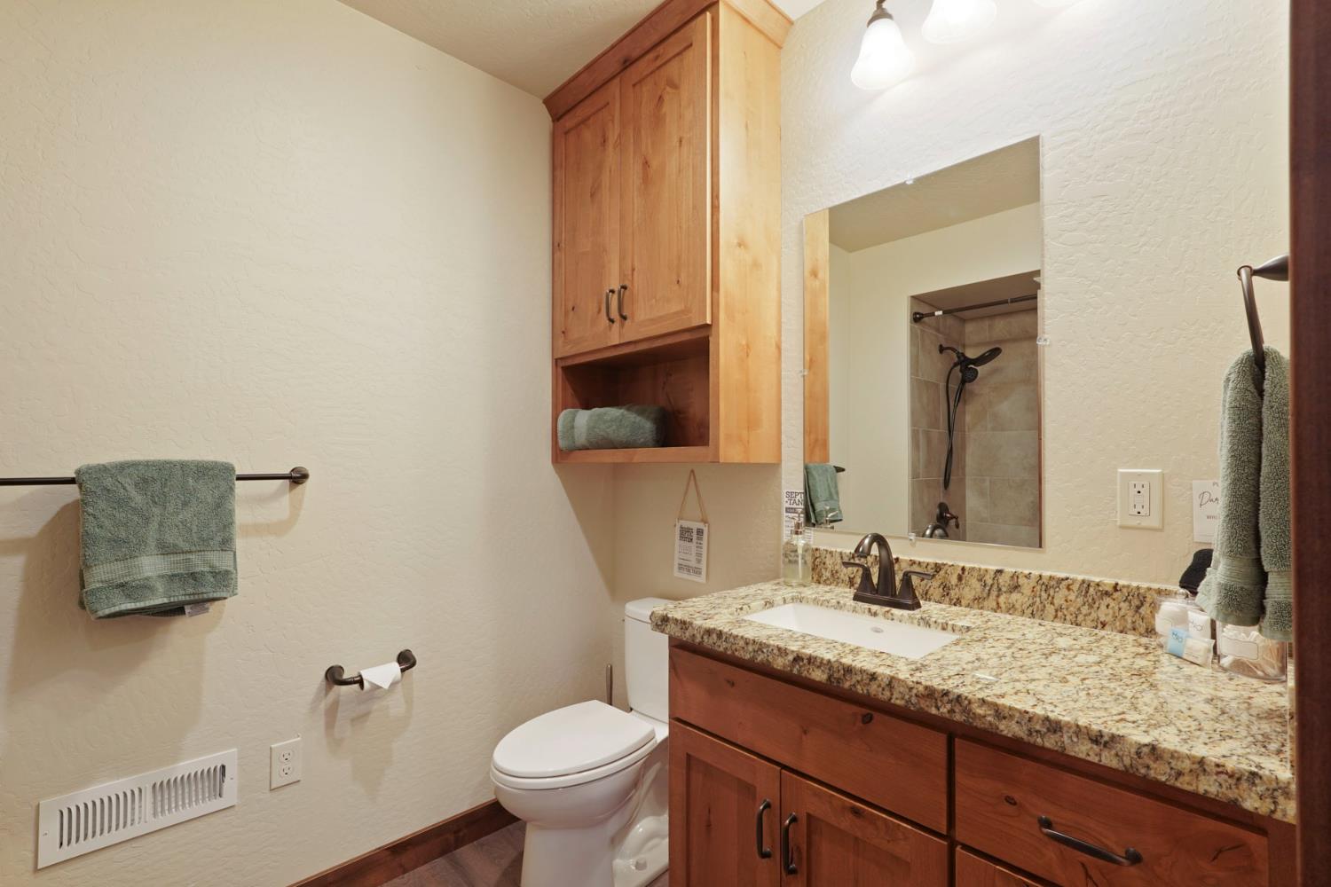 20819 Muheli Road Mi Wuk Village, CA 95346 - Photo 39 of 49 a bathroom with a granite countertop sink and a mirror