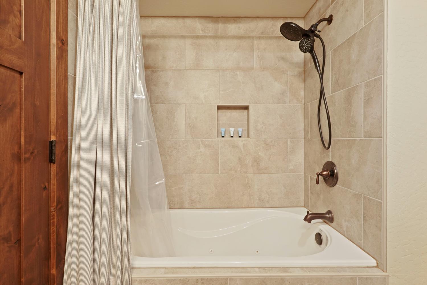 20819 Muheli Road Mi Wuk Village, CA 95346 - Photo 40 of 49 a bathroom with a bath tub and a shower