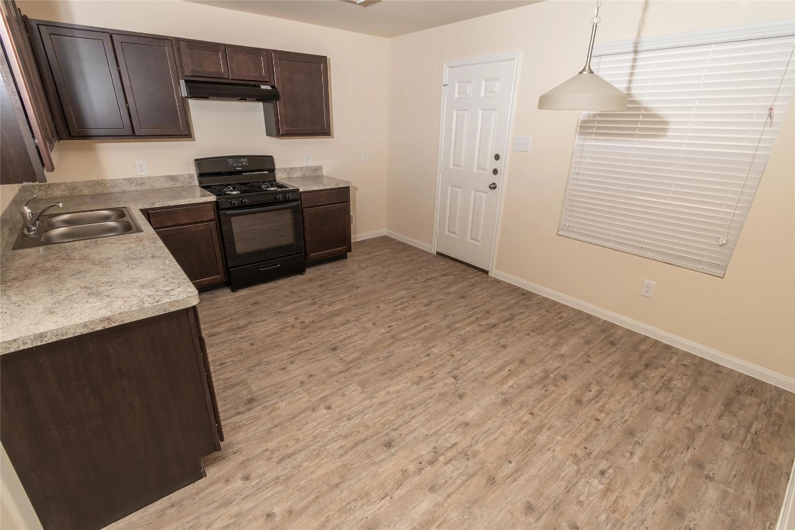 21155 Sprouse Circle Humble, TX 77338 - Photo 3 of 10 a kitchen with a stove and a sink
