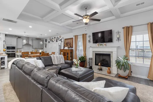 a living room with furniture fireplace and a flat screen tv