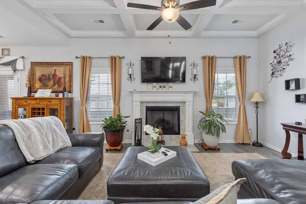 a living room with furniture fireplace and flat screen tv