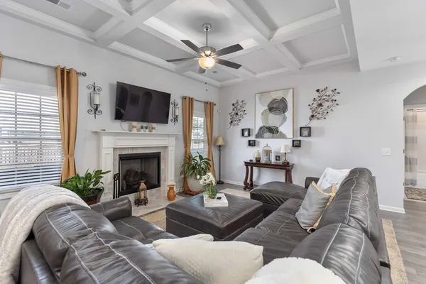 a living room with furniture fireplace and a flat screen tv