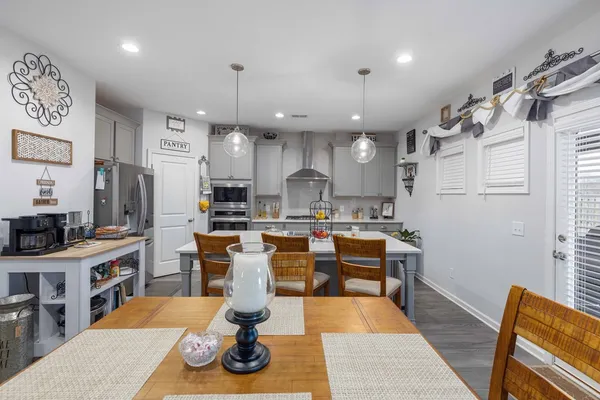 a living room with lots of furniture and kitchen view