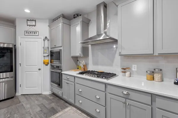 a kitchen with stainless steel appliances granite countertop a refrigerator sink and stove