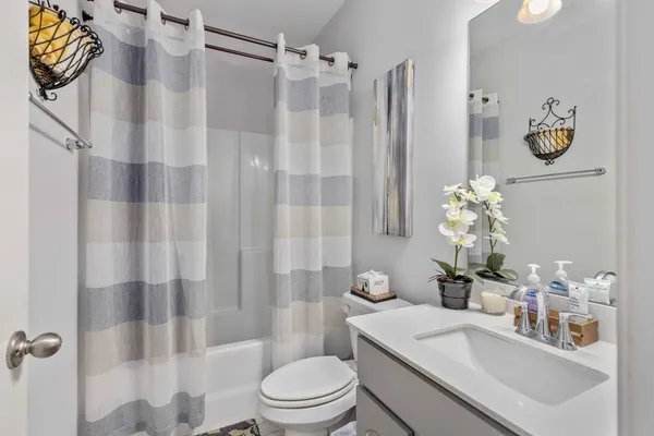 a bathroom with a sink toilet and shower