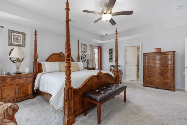 a bedroom with bed and a chandelier