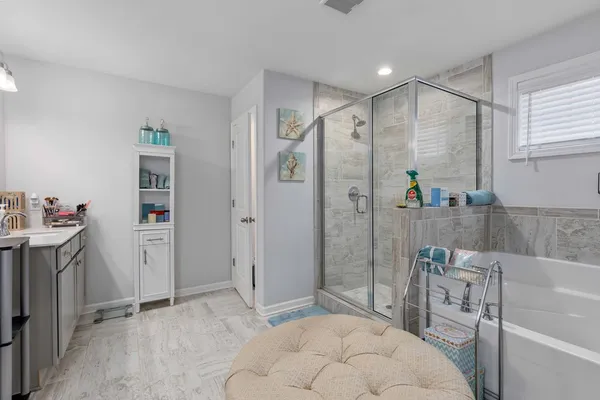 a spacious bathroom with a tub shower and sink