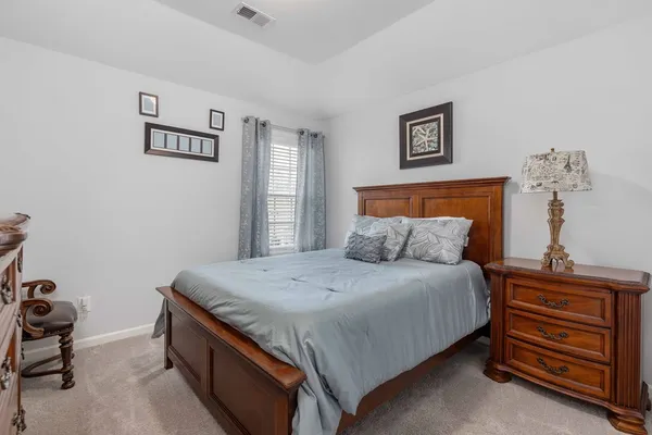 a bedroom with a bed and a dresser