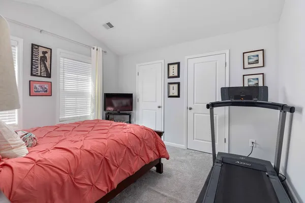 a bedroom with a bed and a fireplace