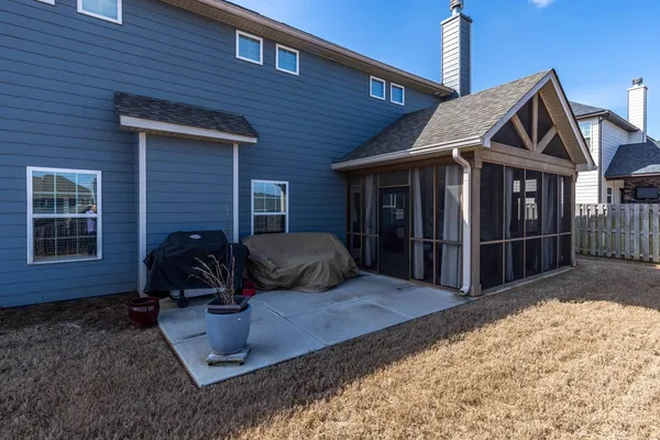 a view of a house with backyard and porch