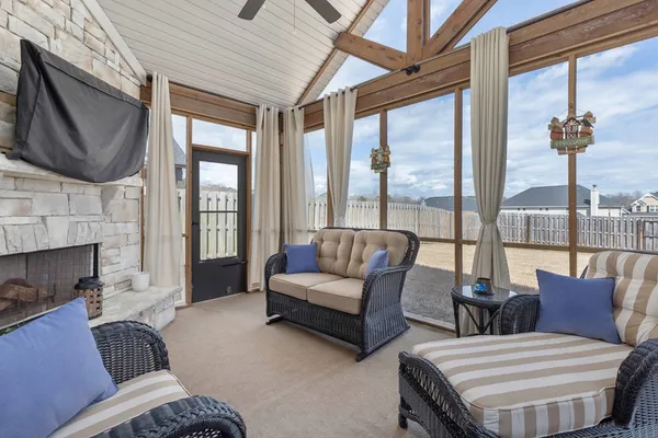 a living room with furniture a fireplace and a flat screen tv