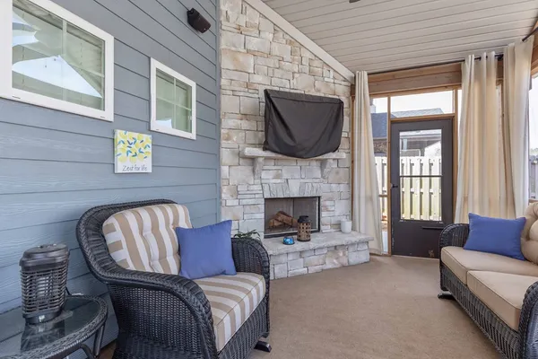 a living room with furniture fireplace and a flat screen tv