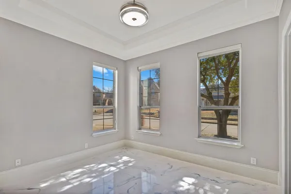 a view of an empty room with windows