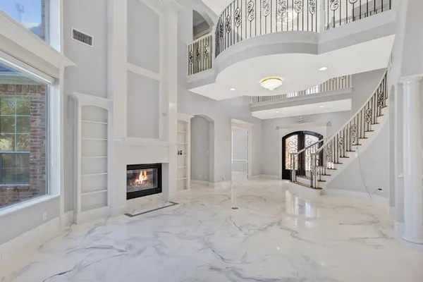 a view of a livingroom with an empty space and a fireplace