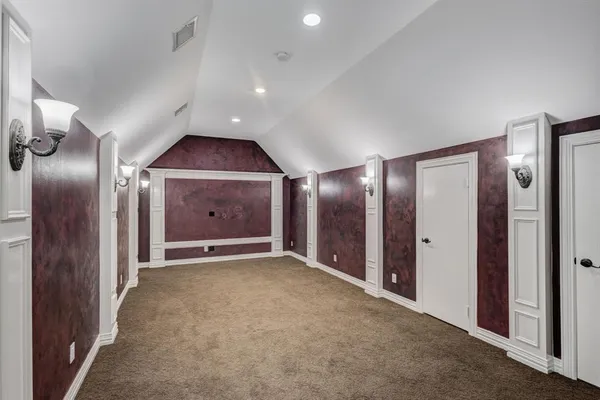 an empty room with fan and entrance