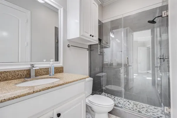 a view of a hallway with wooden floor and chandelier