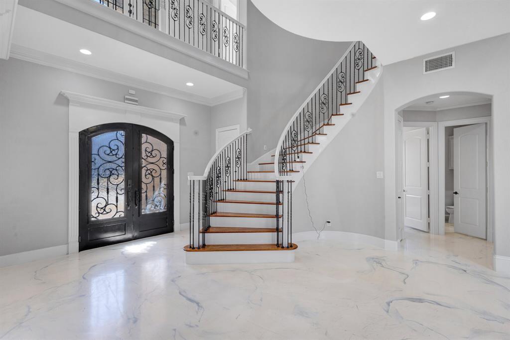 1004 Drake Drive Euless, TX 76039 - Photo 7 of 39 Wide entry perspective showcasing double-height design, luxury finishes, and expansive vertical space.