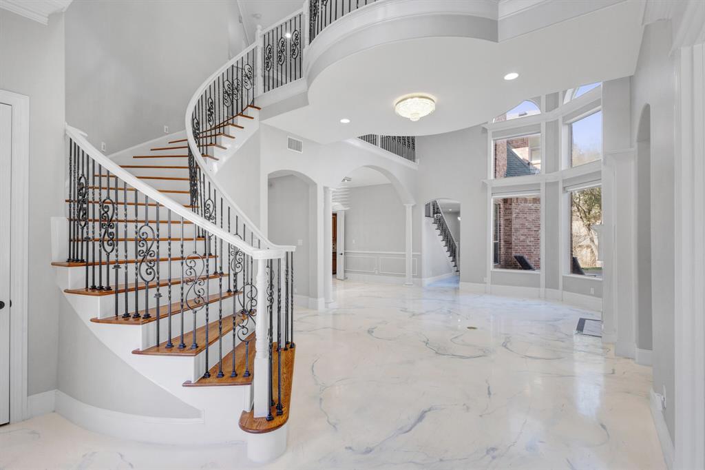 1004 Drake Drive Euless, TX 76039 - Photo 8 of 39 Grand entry with soaring 35-foot ceilings, bright open space, and elegant staircase creating a dramatic first impression.
