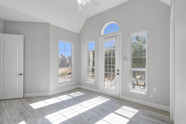a view of a room with windows and wooden floor