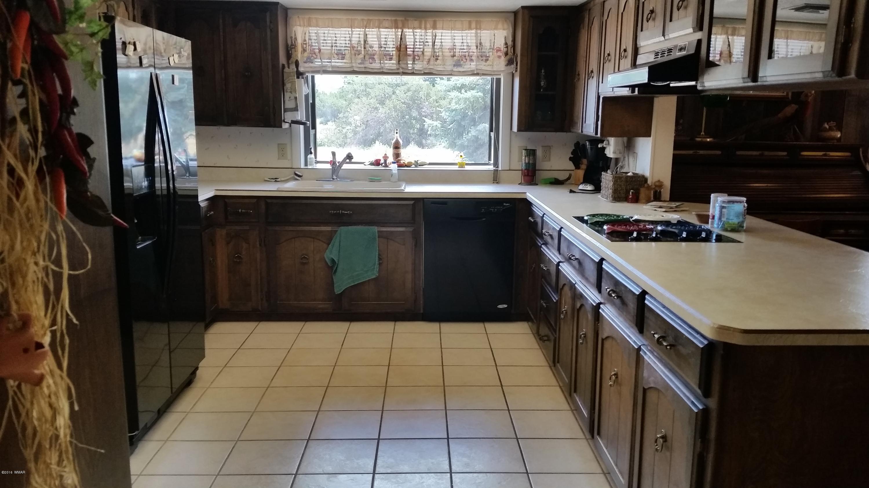 791 West 4th Street South Snowflake, AZ 85937 - Photo 13 of 46 a kitchen with a sink a stove and a refrigerator