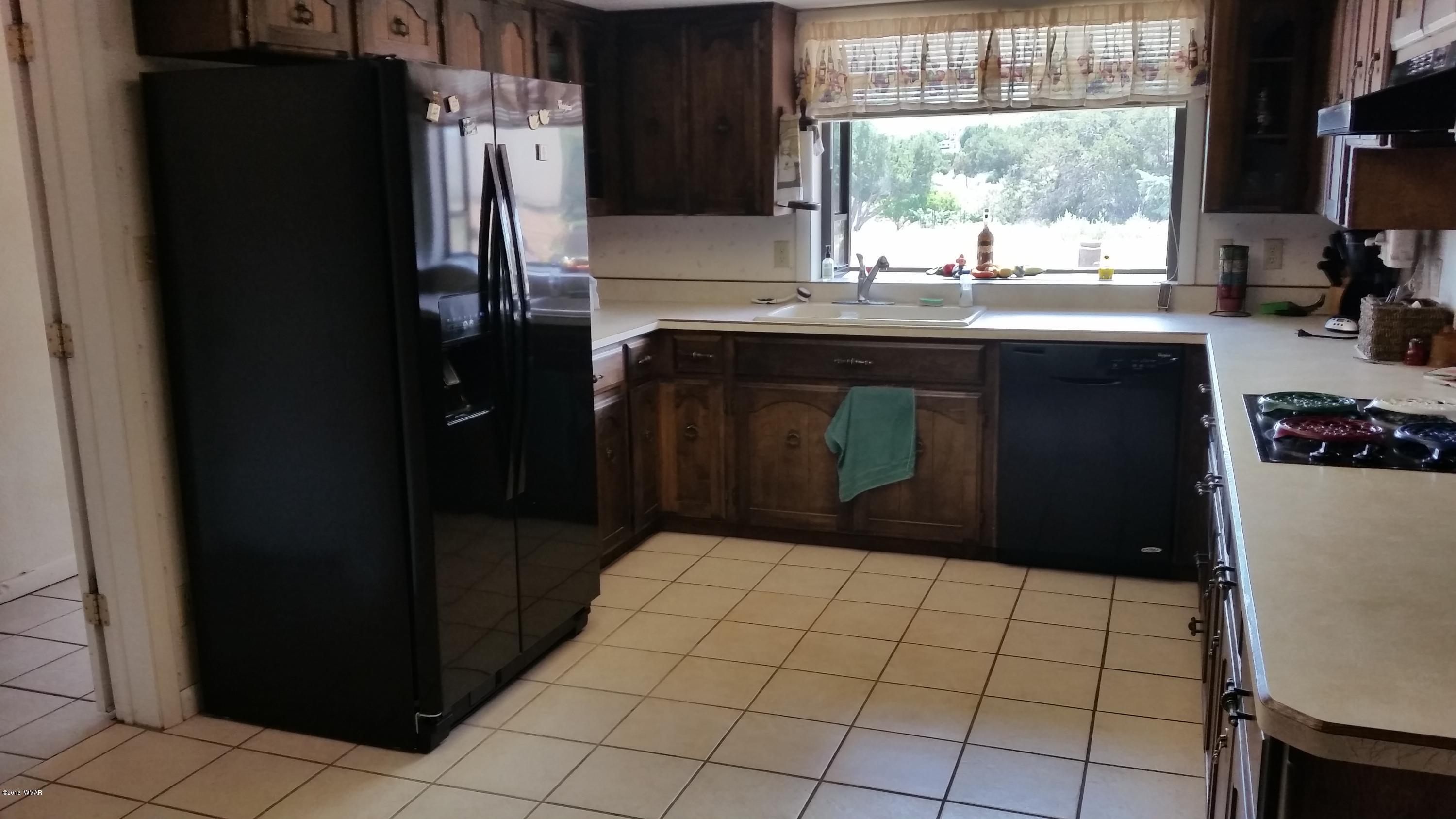 791 West 4th Street South Snowflake, AZ 85937 - Photo 14 of 46 a kitchen with a sink a window and cabinets