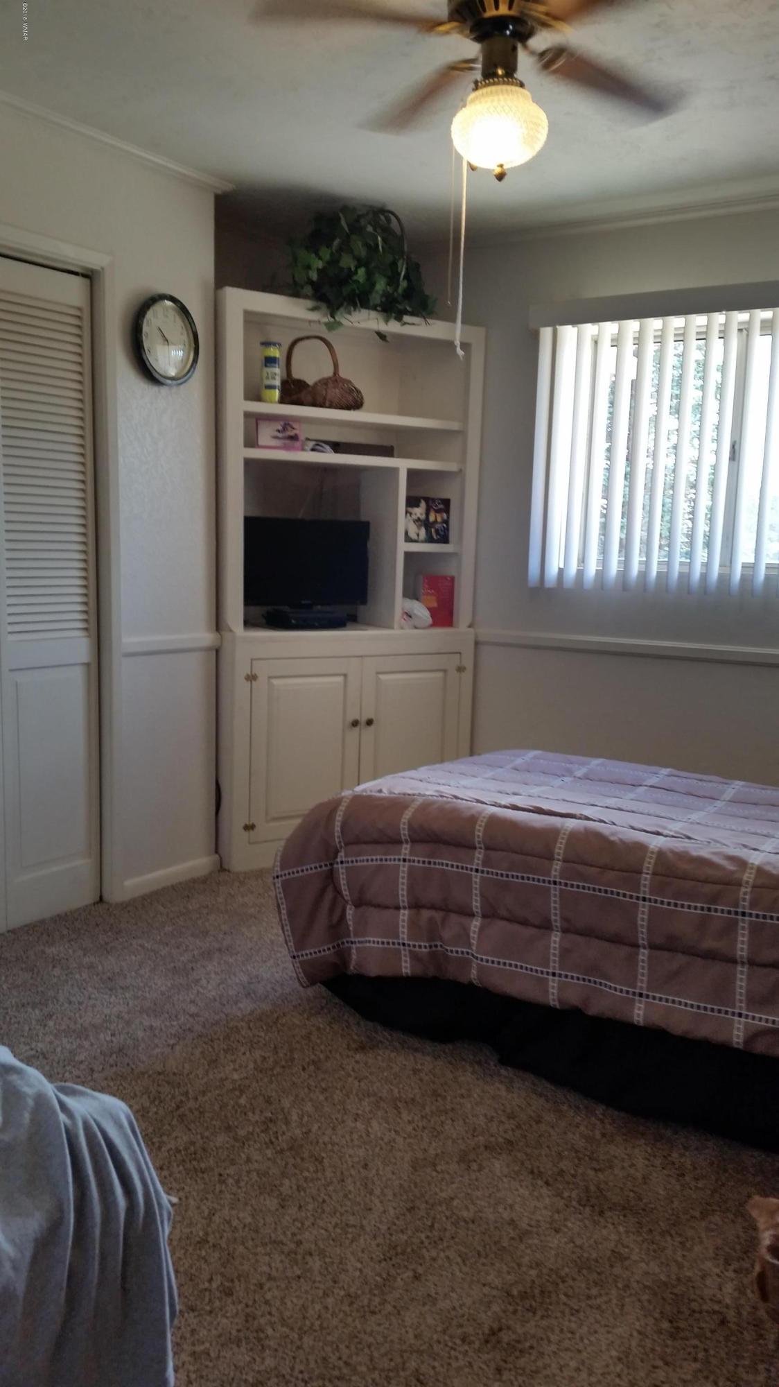 791 West 4th Street South Snowflake, AZ 85937 - Photo 26 of 46 a bedroom with a bed and a chandelier