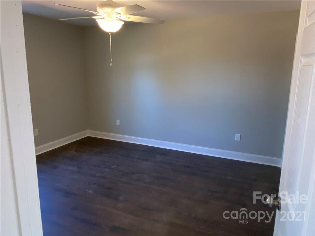 3765-l L L L Davis Road Clover, SC 29710 - Photo 7 of 13 a view of a room with wooden floor and a ceiling fan