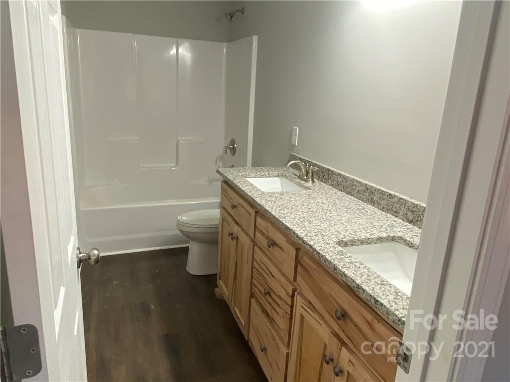 3765-l L L L Davis Road Clover, SC 29710 - Photo 8 of 13 a bathroom with a granite countertop sink toilet and shower
