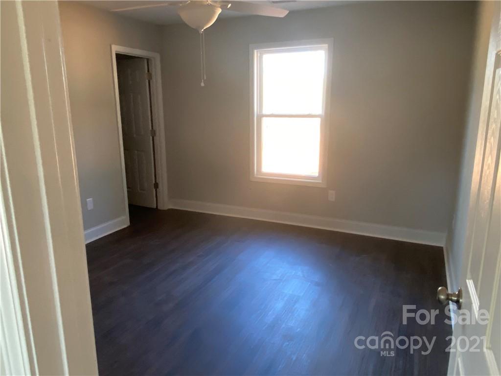 3765-l L L L Davis Road Clover, SC 29710 - Photo 9 of 13 an empty room with wooden floor and windows