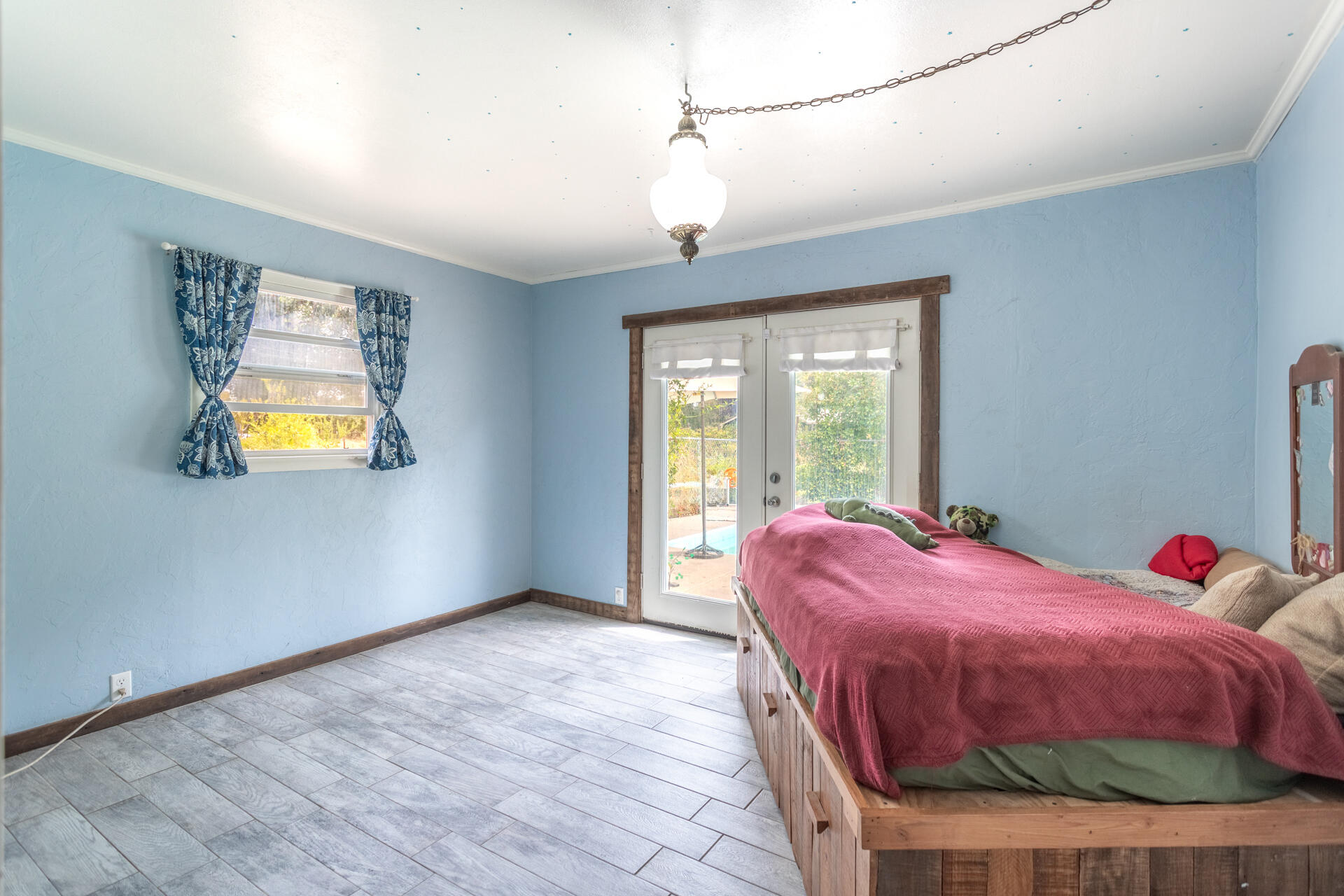 8132 Maynard Road Palo Cedro, CA 96073 - Photo 15 of 35 a bed sitting in a bedroom next to a window