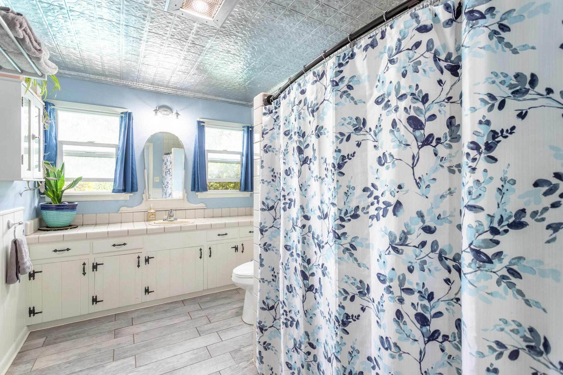 8132 Maynard Road Palo Cedro, CA 96073 - Photo 17 of 35 a bathroom with a granite countertop sink a toilet and a mirror