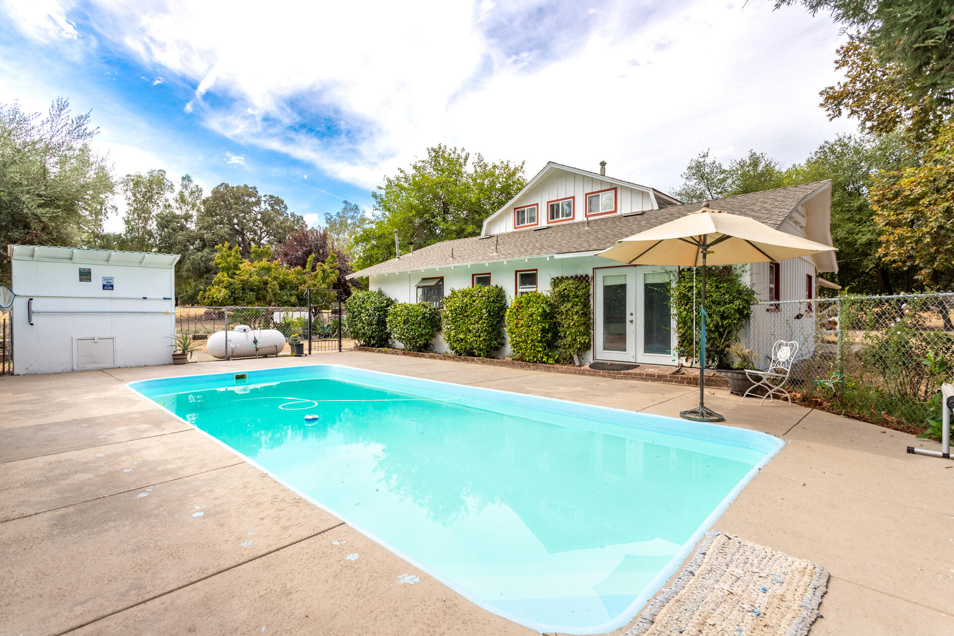 8132 Maynard Road Palo Cedro, CA 96073 - Photo 23 of 35 a view of a house with swimming pool and sitting area