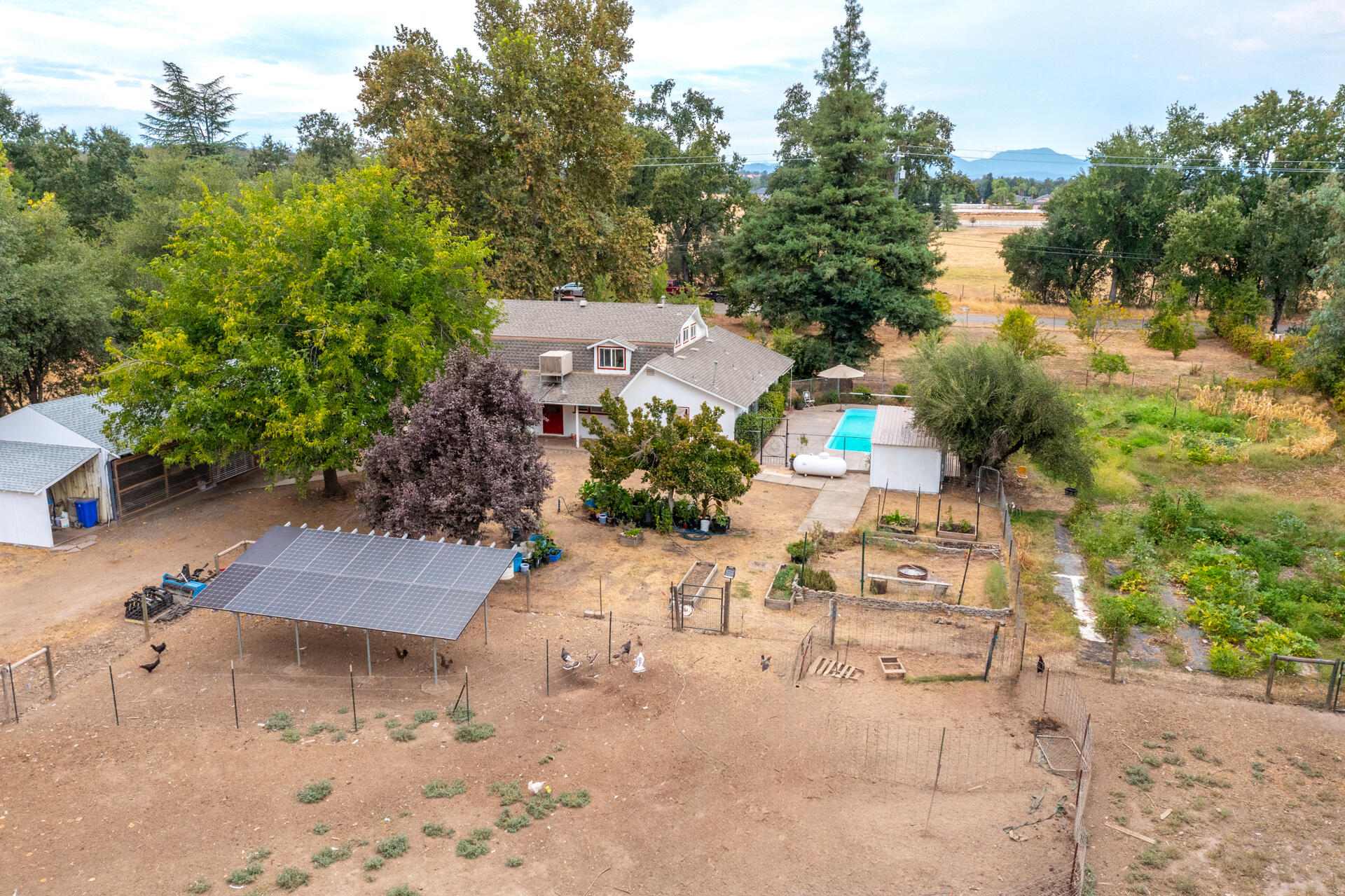 8132 Maynard Road Palo Cedro, CA 96073 - Photo 29 of 35 an aerial view of a house with a yard and trees all around