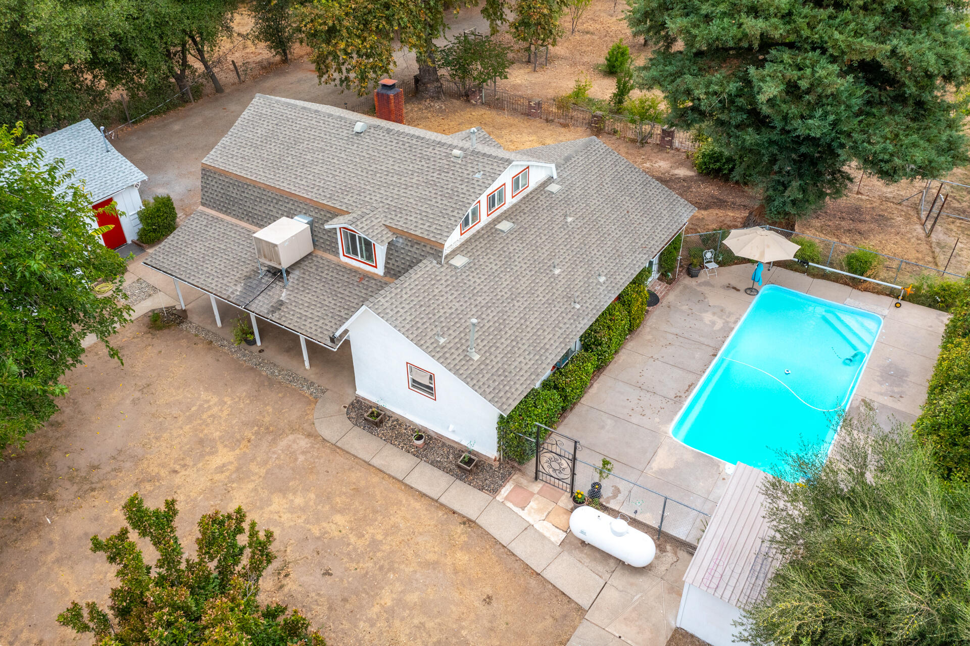 8132 Maynard Road Palo Cedro, CA 96073 - Photo 30 of 35 an aerial view of a house with a garden and swimming pool