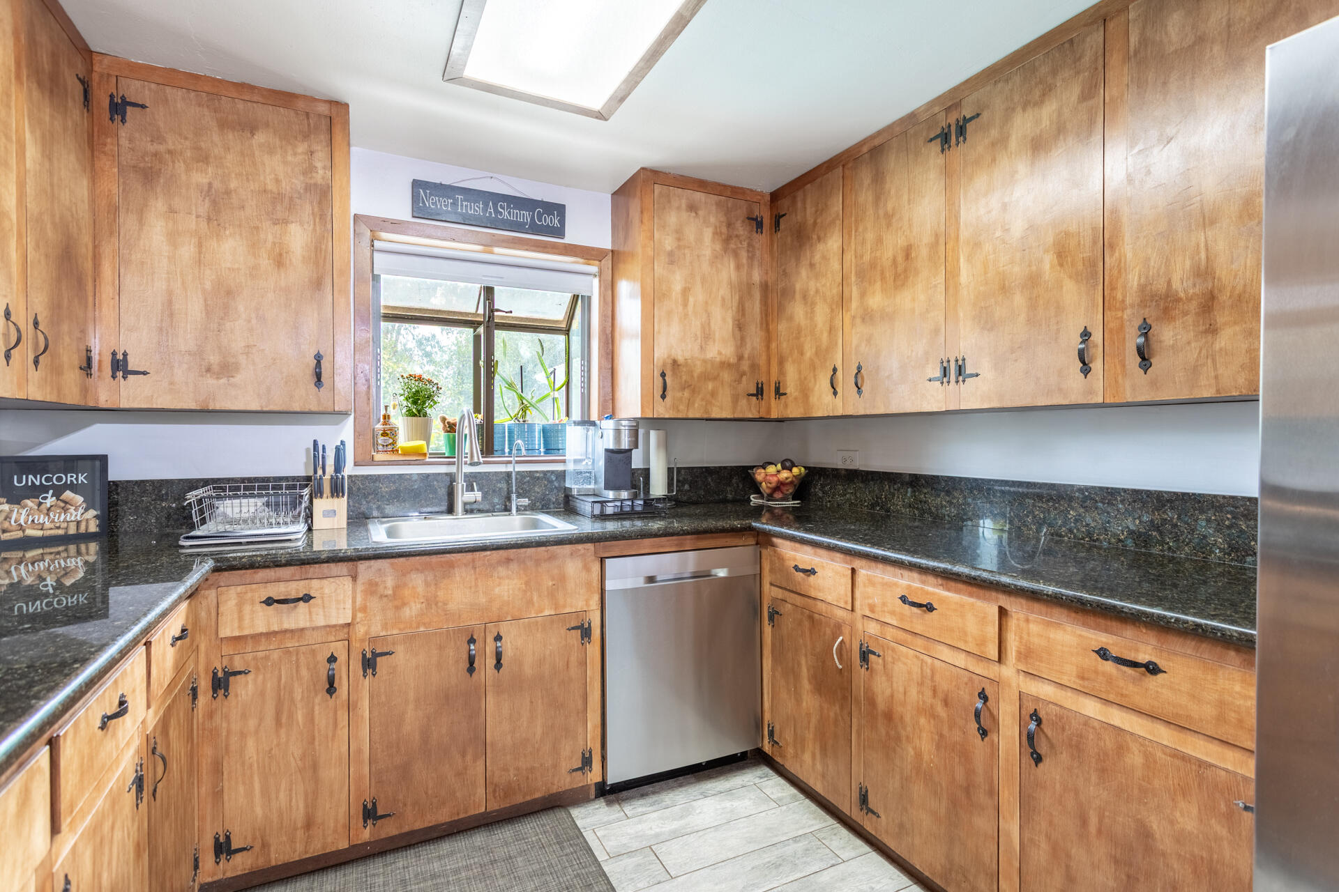 8132 Maynard Road Palo Cedro, CA 96073 - Photo 6 of 35 a kitchen with granite countertop wooden cabinets stainless steel appliances a sink and a window