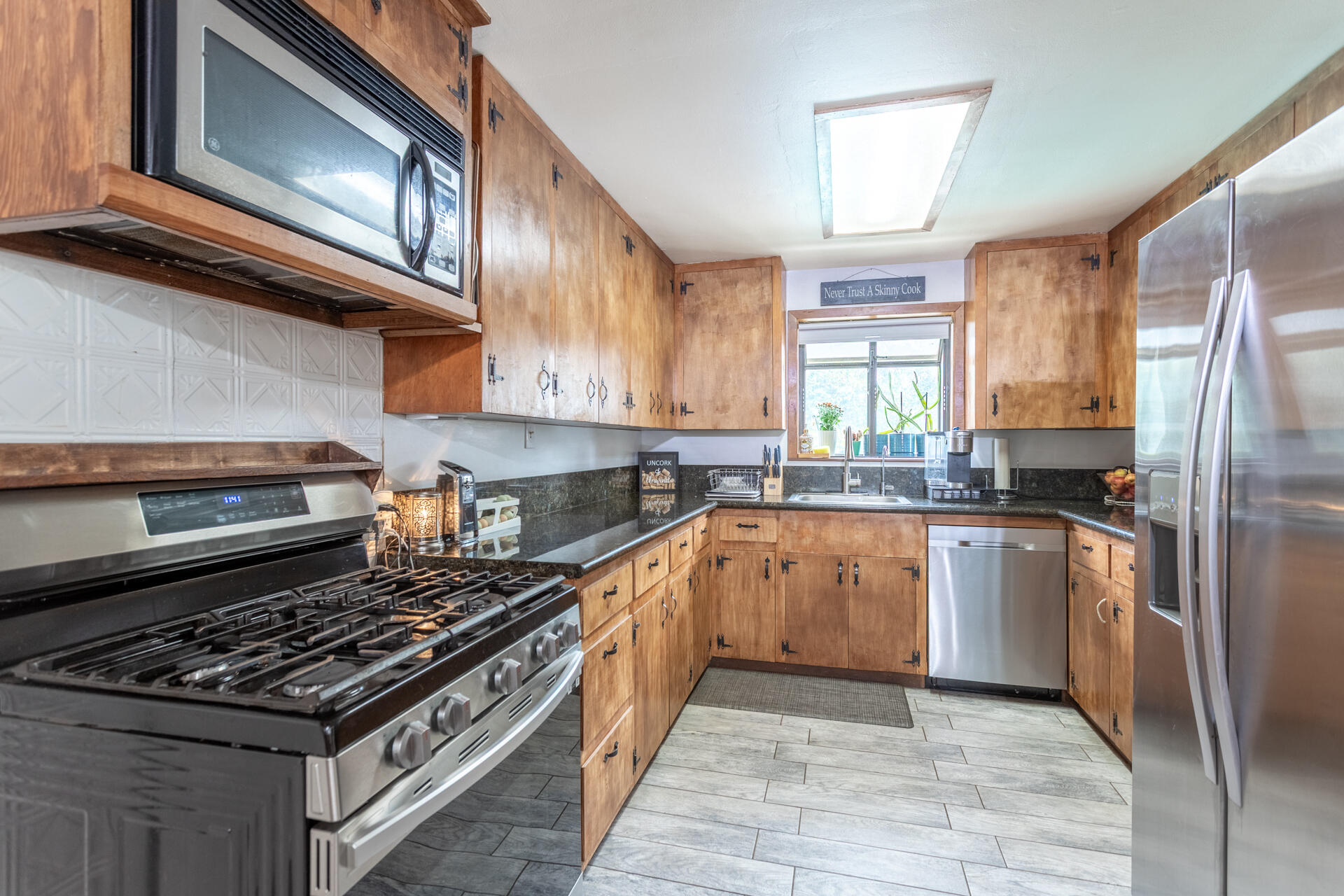 8132 Maynard Road Palo Cedro, CA 96073 - Photo 7 of 35 a kitchen with stainless steel appliances granite countertop a stove a sink and a refrigerator