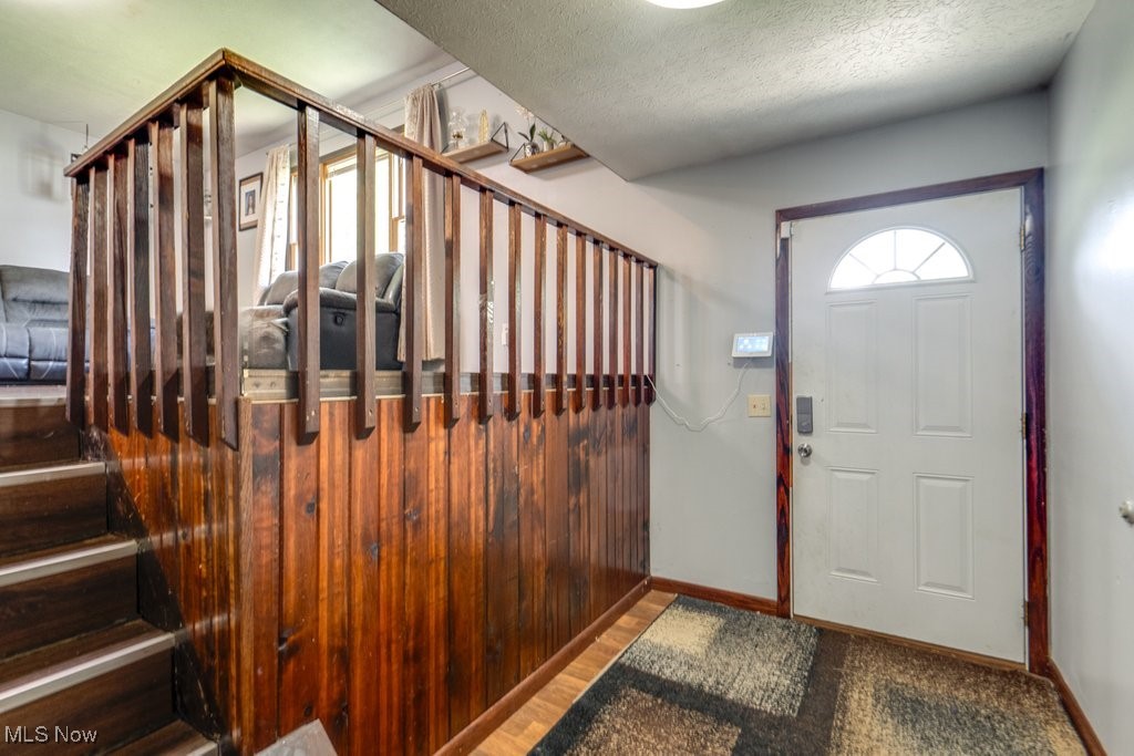 8998 Horn Road Windham, OH 44288 - Photo 8 of 34 Foyer entrance featuring stairway and a textured ceiling