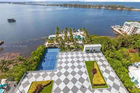 a view of a lake with couches and wooden floor