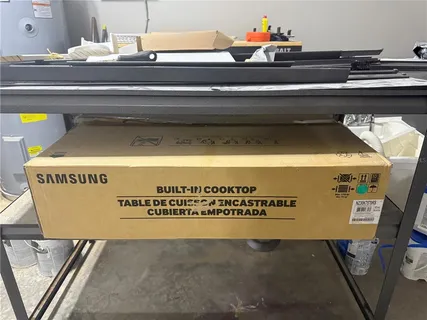 an empty room with wooden floor chandelier fan and windows