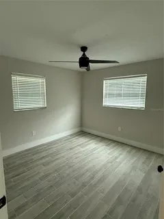 a bathroom with a double vanity sink and mirror with toilet
