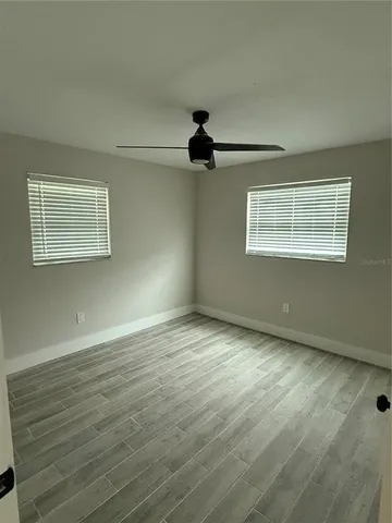 a bathroom with a double vanity sink and mirror with toilet