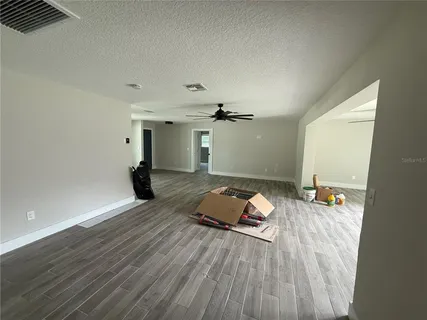 a view of cabinets with stainless steel appliances wooden floor and window