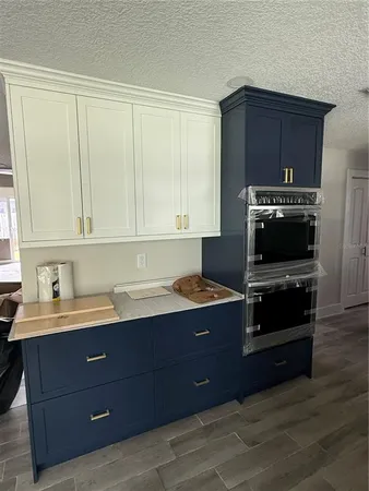 a stove top oven sitting inside of a kitchen