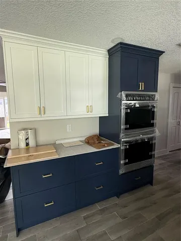 a stove top oven sitting inside of a kitchen